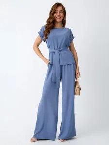 Detailed view of the elegant blue two-piece set featuring a loose top and wide-leg trousers.