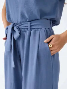 Blue two-piece casual shirt and pants set with belt detail, elegant French style outfit.