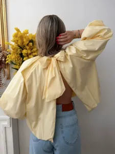 French style solid color backless blouse with big bow, puff sleeves and chic halter neck.