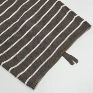 Close-up of brown and white striped knit fabric texture details, soft and breathable material.