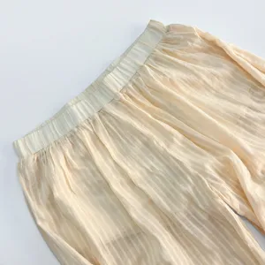 Close up detail of women summer lightweight casual striped balloon pants elastic waistband.