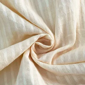 Light beige striped fabric detail, soft breathable summer clothing material closeup.