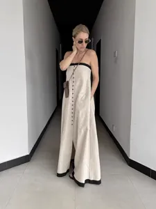 Elegant strapless linen maxi dress with front buttons, chic off-shoulder casual summer wear.