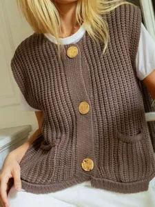 Chunky knit sleeveless cardigan vest for women with large gold buttons and front pockets.