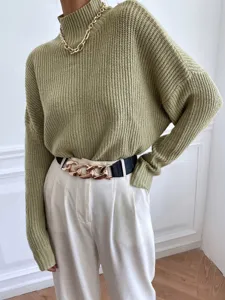 Detailed view of the cozy olive green turtleneck knitted sweater, soft texture, stylish fit.