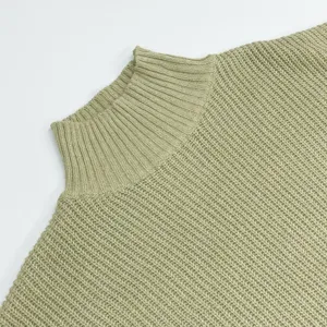 Close-up of light green ribbed turtleneck sweater knit texture, cozy winter essential detail.