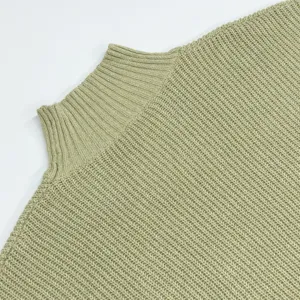 Close-up detail view of women's light green high neck knitted sweater showing fine knit texture.