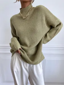 Close-up detail of women's casual olive green turtleneck chunky knit sweater outfit scene.