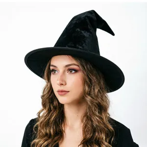 Close-up detail view showing the soft texture and shape of the black velvet witch hat.