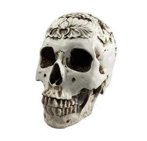 Detailed close-up of a carved resin skull model with floral top for Halloween and decor.