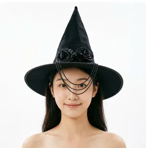 Close-up detail of the black Halloween witch hat featuring fabric roses and hanging bead chains.
