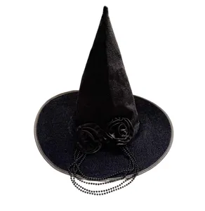 Black witch hat detail showing fabric roses and beaded chains for Halloween party decor.