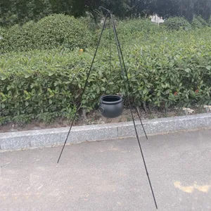 Outdoor camping tripod with hanging witch pot for Halloween, portable black iron campfire rack.