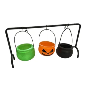 Halloween witch cauldron candy bucket set with black metal display stand for party decor.