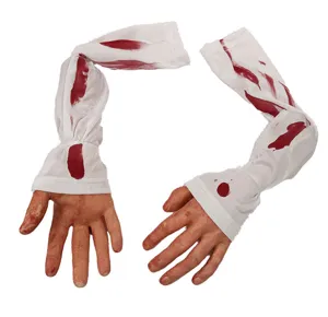 Detailed shot of Halloween bloody fake arm and severed hand prop with white striped sleeve.