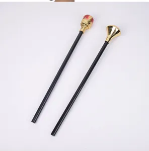 Close-up of Halloween party plastic magic wands with black handles and gold crown or diamond heads.