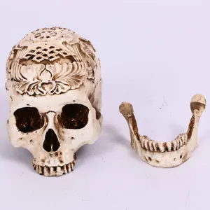 Resin carved skull detail shot showing intricate traditional patterns and detachable jawbone.