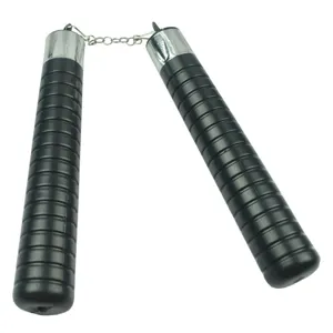 Close-up of black plastic nunchucks with textured grip and metal chain link detail.