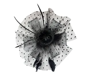Close-up details of black vintage mesh feather fascinator hat decorated with polka dots and bows.
