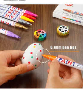 Detail shot showing 0.7mm fine pen tips drawing colorful dots on an egg surface easily.