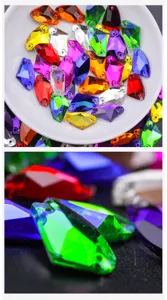 Close-up detail of colorful axe-shaped glass sew-on rhinestones with dual holes for DIY apparel.