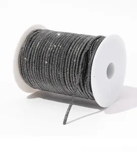 Detail view of dark grey 6-row rhinestone chain spool for DIY crafts and apparel decor.