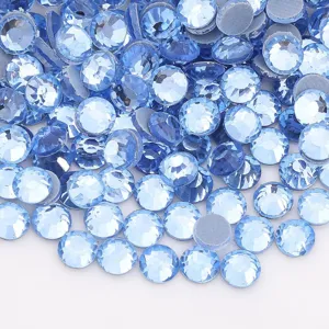 Detail shot of light blue flatback rhinestones, sparkling glass crystal diamonds for DIY crafts.