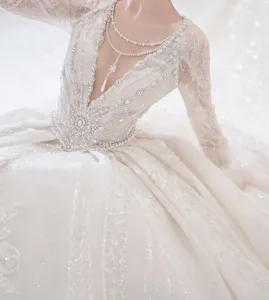 Luxurious lace wedding dress detail shot featuring intricate hand-sewn rhinestones and crystals.