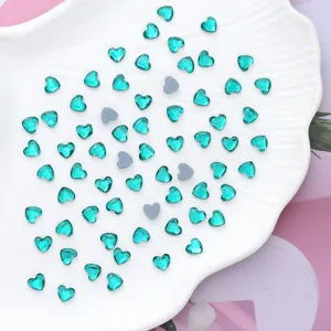 Teal heart crystal rhinestones detail shot, flatback glass gems for nail art and decor.