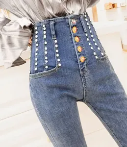 High-waisted denim jeans featuring elegant pearl embellishments and colorful button closures.