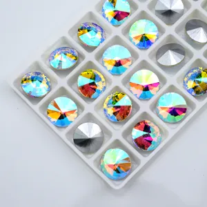 Close-up detail of sparkling round pointed-bottom glass crystal rhinestones with rainbow AB coating.