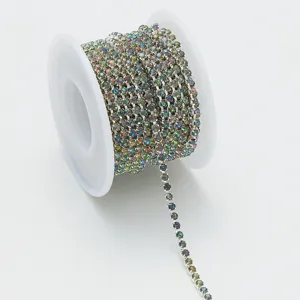 Detailed shot of a roll of colorful crystal rhinestone claw chain for DIY nail art and crafts.