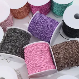 Detailed close-up of colorful DIY bead chains on white spools, vibrant metal chains for jewelry.
