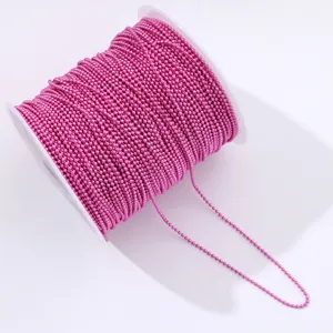 Close-up roll of vibrant hot pink ball chain for nail art and DIY jewelry crafting.