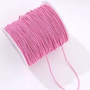 Pink ball chain spool for nail art and DIY crafts. Vibrant color beaded chain roll.