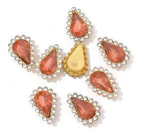 Close-up details of drop-shaped acrylic claw rhinestones with white crystals for DIY crafts items