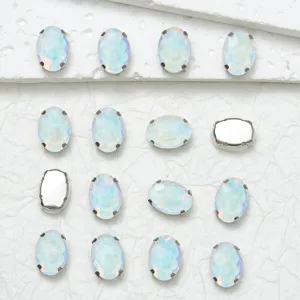 Close-up detail of oval iridescent glass rhinestones with metal claw settings for DIY crafts.