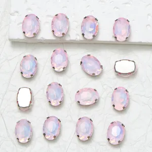 Detailed view of oval pink glass rhinestones with claw settings for DIY apparel crafts.