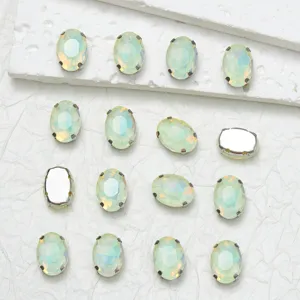 Oval glass sew-on rhinestones with metal claw settings for DIY clothing and jewelry crafts.