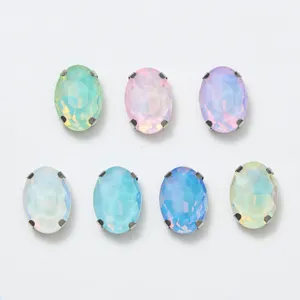 Closeup of oval glass rhinestones with silver claw settings, colorful DIY craft accessories.