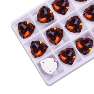 Amber triangle crystal rhinestones close up, faceted glass sew on buttons for garments.