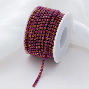 Detail shot of gradient AB color glass rhinestone cup chain, sparkling crystals on white spool.
