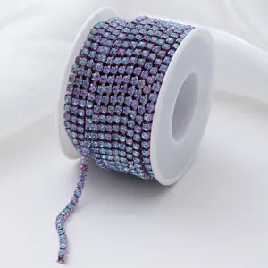 Close-up view of a gradient purple rhinestone chain spool for DIY crafts and apparel.