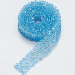 Close up detail of light blue resin rhinestone ribbon roll, sparkling crystal trim for DIY.