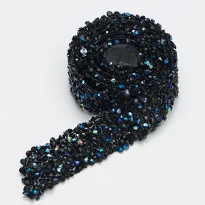 Detailed view of black resin rhinestone trim, sparkling crystal diamond ribbon for DIY crafts.