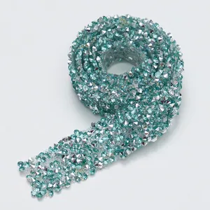 Blue resin rhinestone strip detail, sparkling crystal diamond sticker close-up for crafts.
