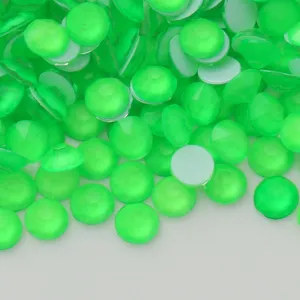 Close-up detail of neon green flatback rhinestone crystals for DIY crafts and nail art.