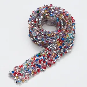 Close-up detail of sparkling multicolored resin rhinestone ribbon trim for DIY crafts and decor.