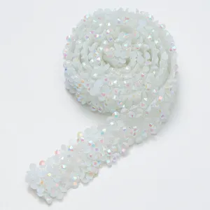 Detailed view of the sparkling white iridescent resin rhinestone trim, showing exquisite lace texture.