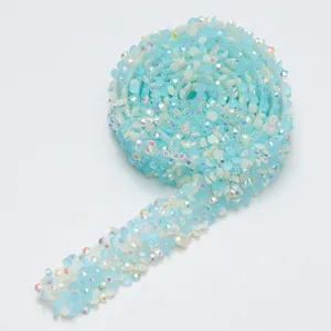 Close up of light blue resin rhinestone ribbon trim, shiny crystal mesh for DIY crafts.